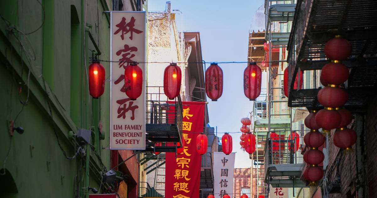 Red paper lanterns filling a narrow Chinatown alley